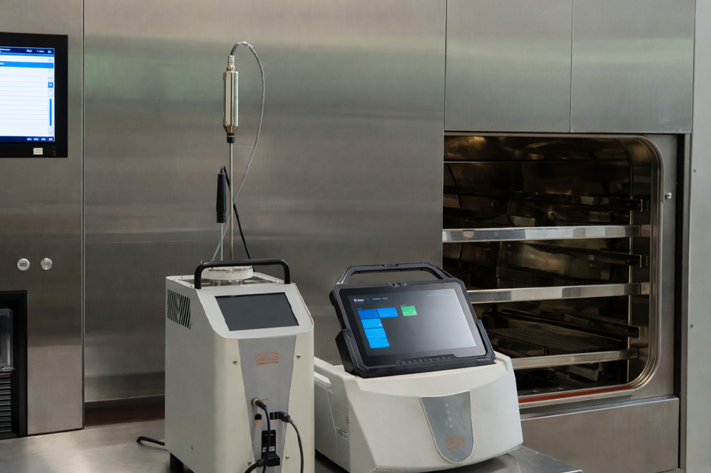 Kaye Validator temperature mapping system positioned in front of pharmaceutical steam autoclave during sterilization qualification.