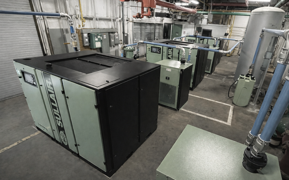 Industrial compressed air system showing compressors, dryers, filtration, and air receivers installed in a GMP manufacturing facility.