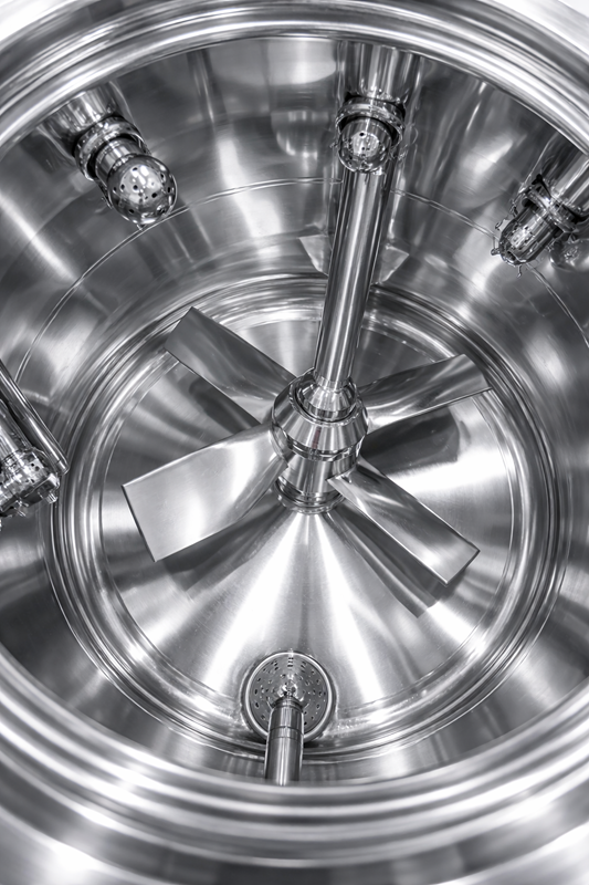 Polished stainless steel interior of pharmaceutical tank showing smooth surface finish and sanitary weld.